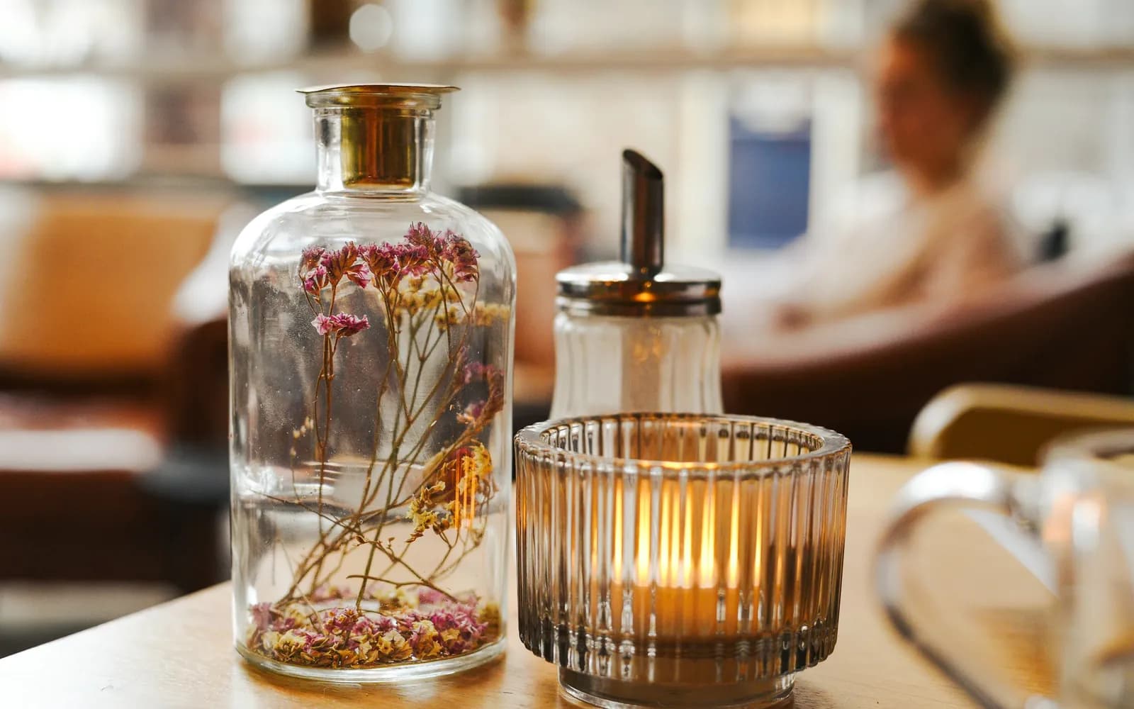 Tafel met een brandend theelichtje en droogbloemen in een café in Groningen